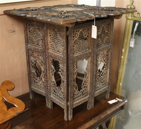 An Indian carved occasional table W.64cm